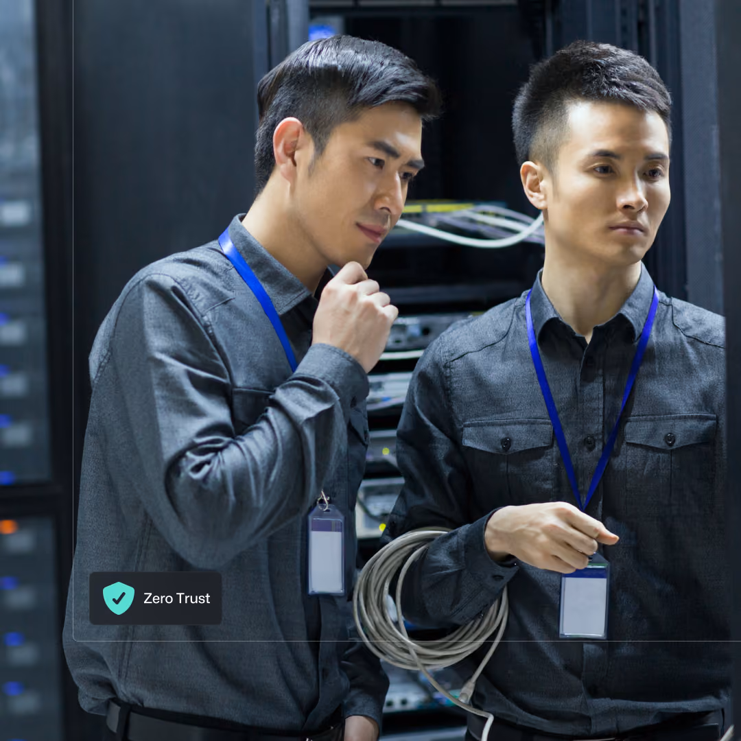 Two network engineers discussing the best layout for the server rack they are working on.