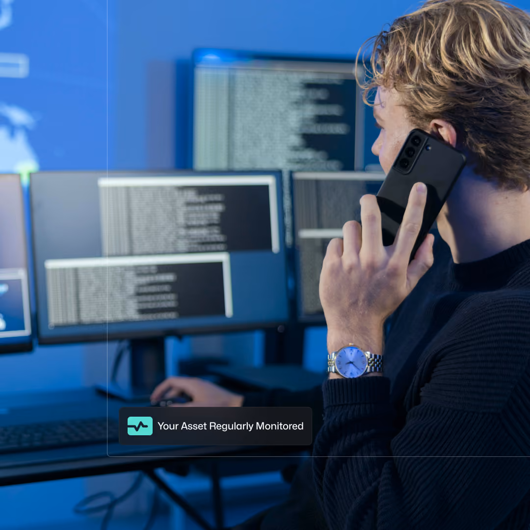 A network engineer checking on the health of a server, on the phone with the owner.