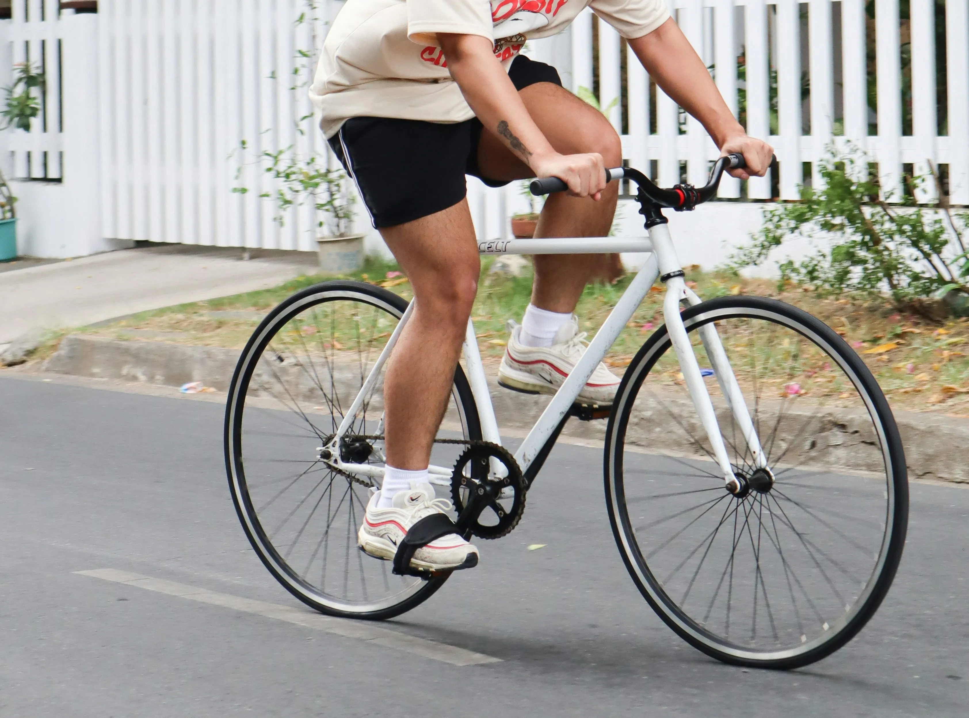 Picture of a person biking down a suburban street