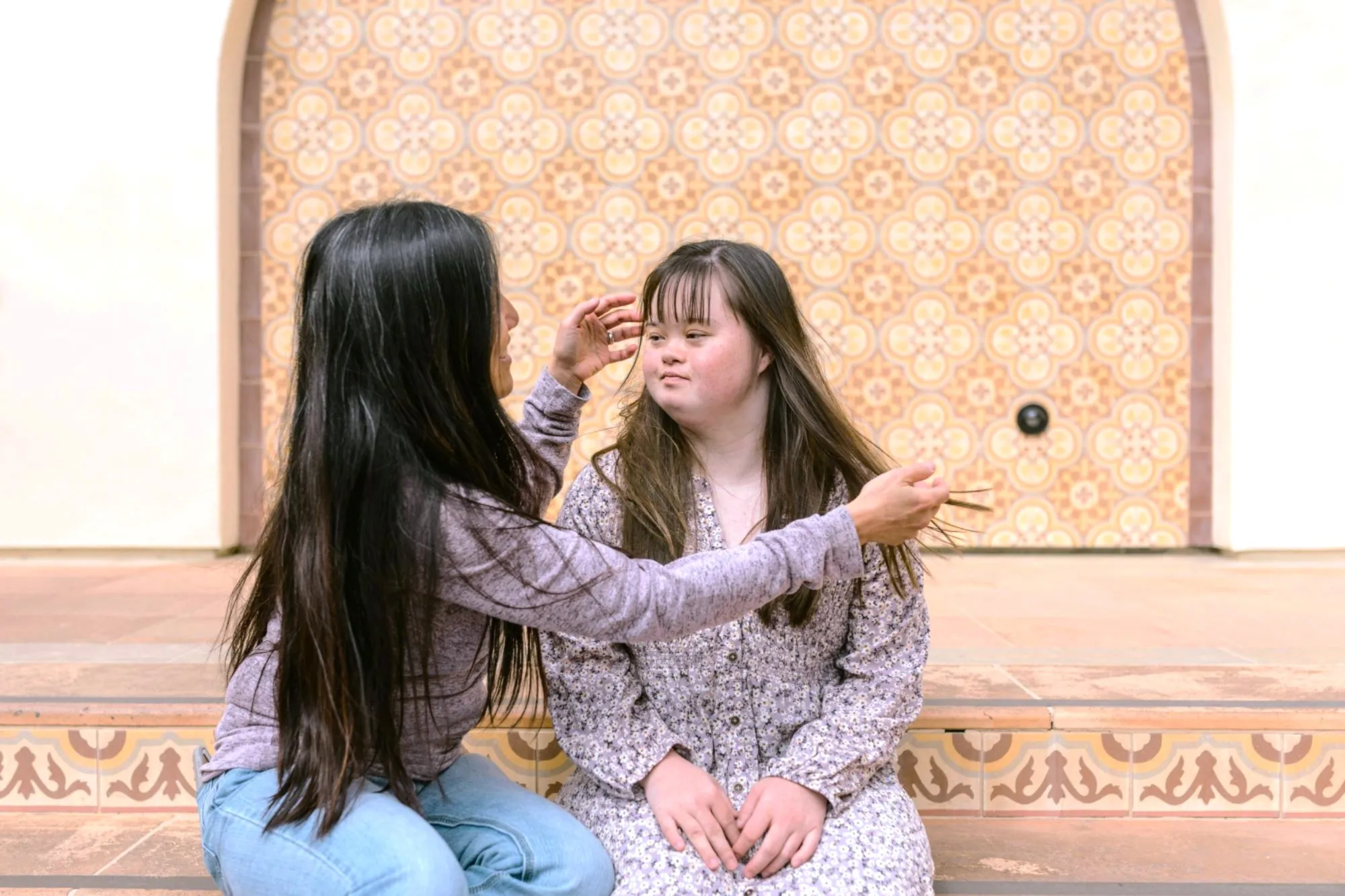 A mother sits with her disabled daughter