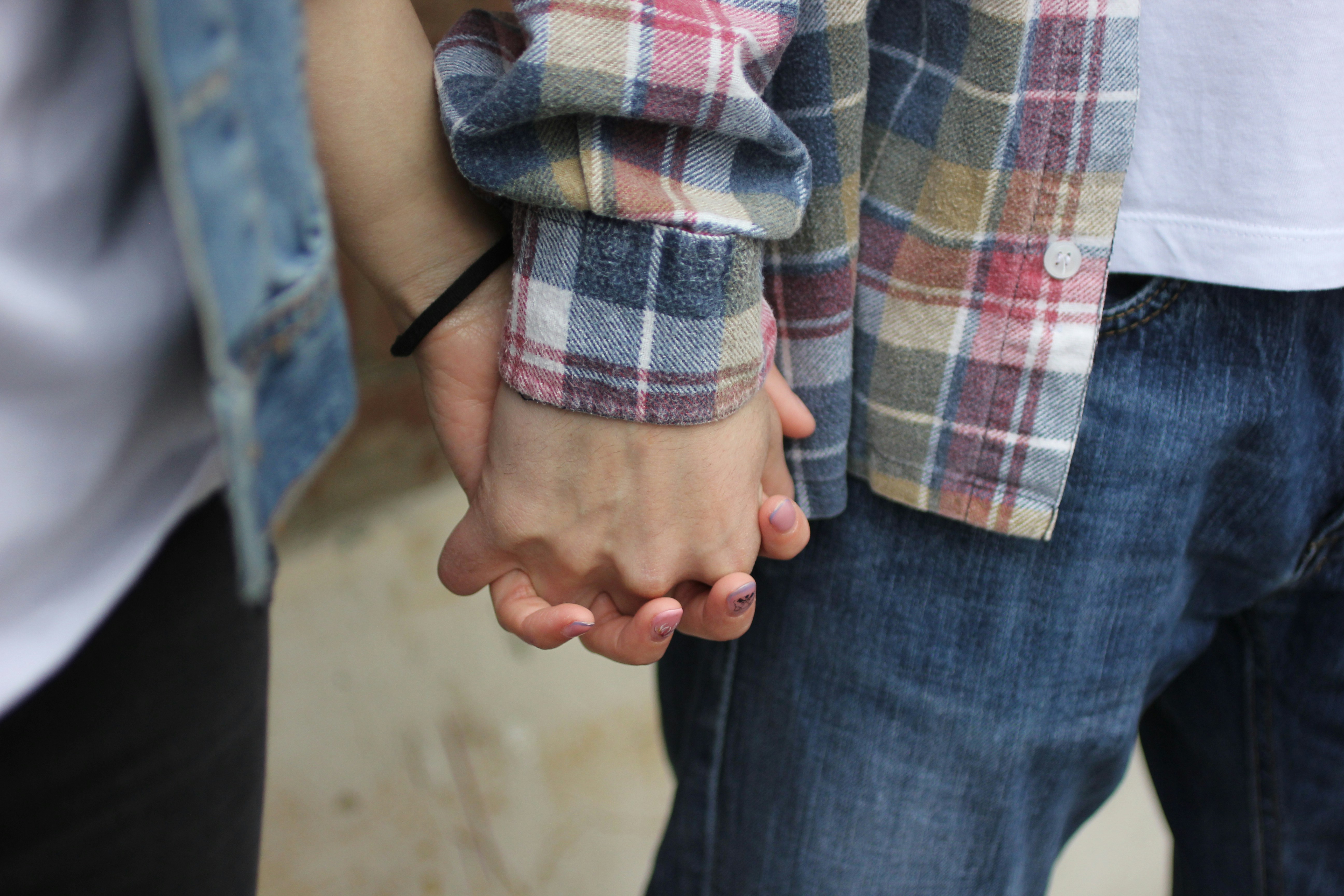 Two people holding hands