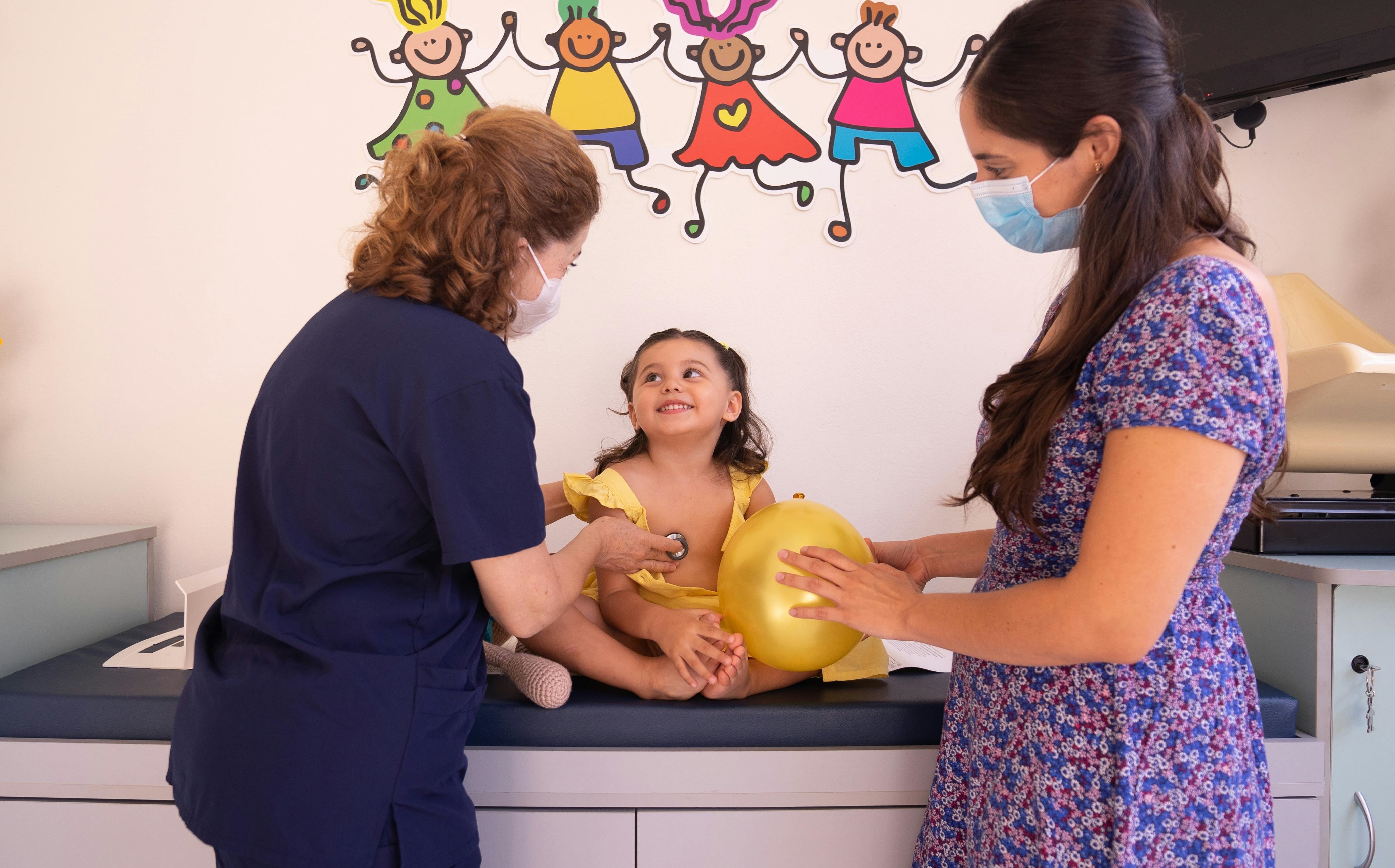 A mother and her baby in a doctor's office.