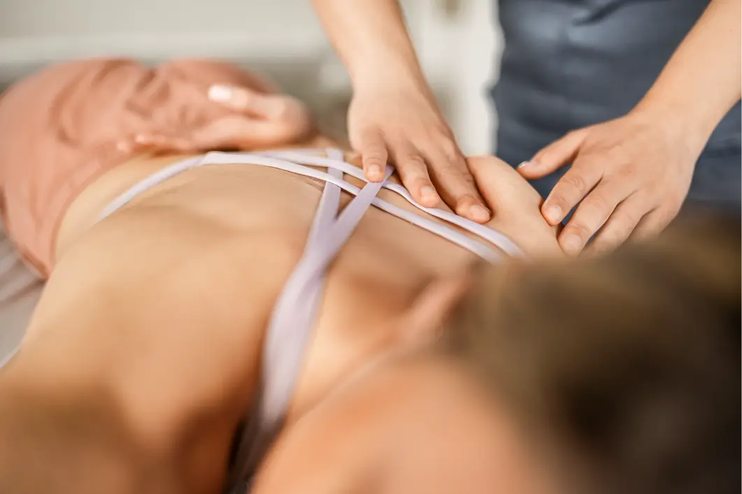 Close-up of a person receiving a back massage from another person.