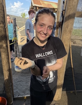 Jordan Evans holding newly hatched turtles at the refuge.