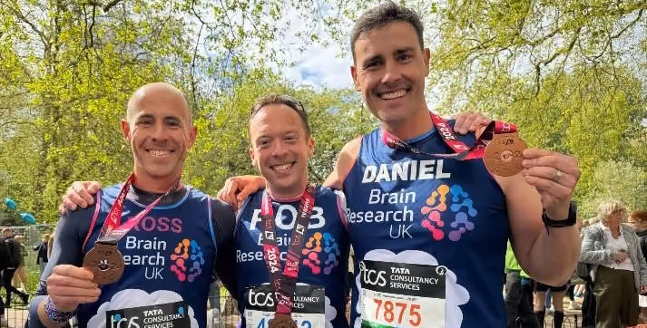 Dan with his friends showing of their medals after completing the charity raise for Brain Research UK