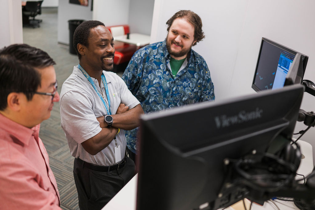work group sitting at computer station in durham MSP office
