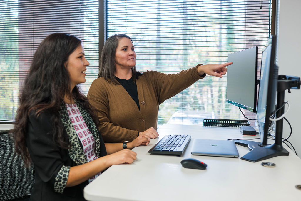 IT technicians solving a problem on a whiteboard