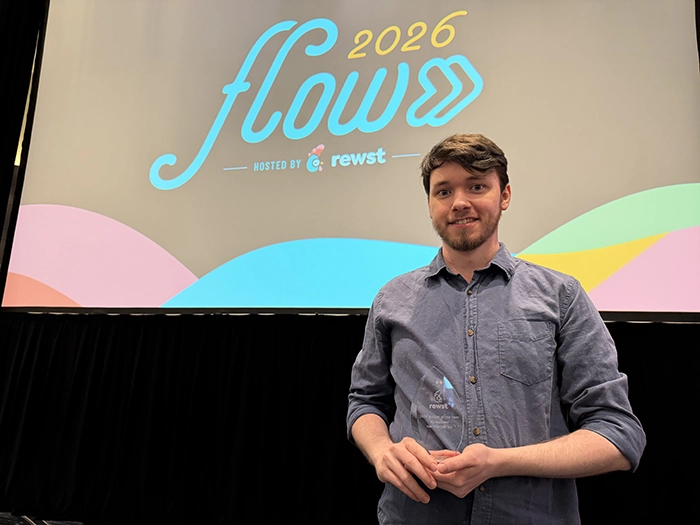 RJ Madsen with his Builder of the Year award at Rewst Flow 2026