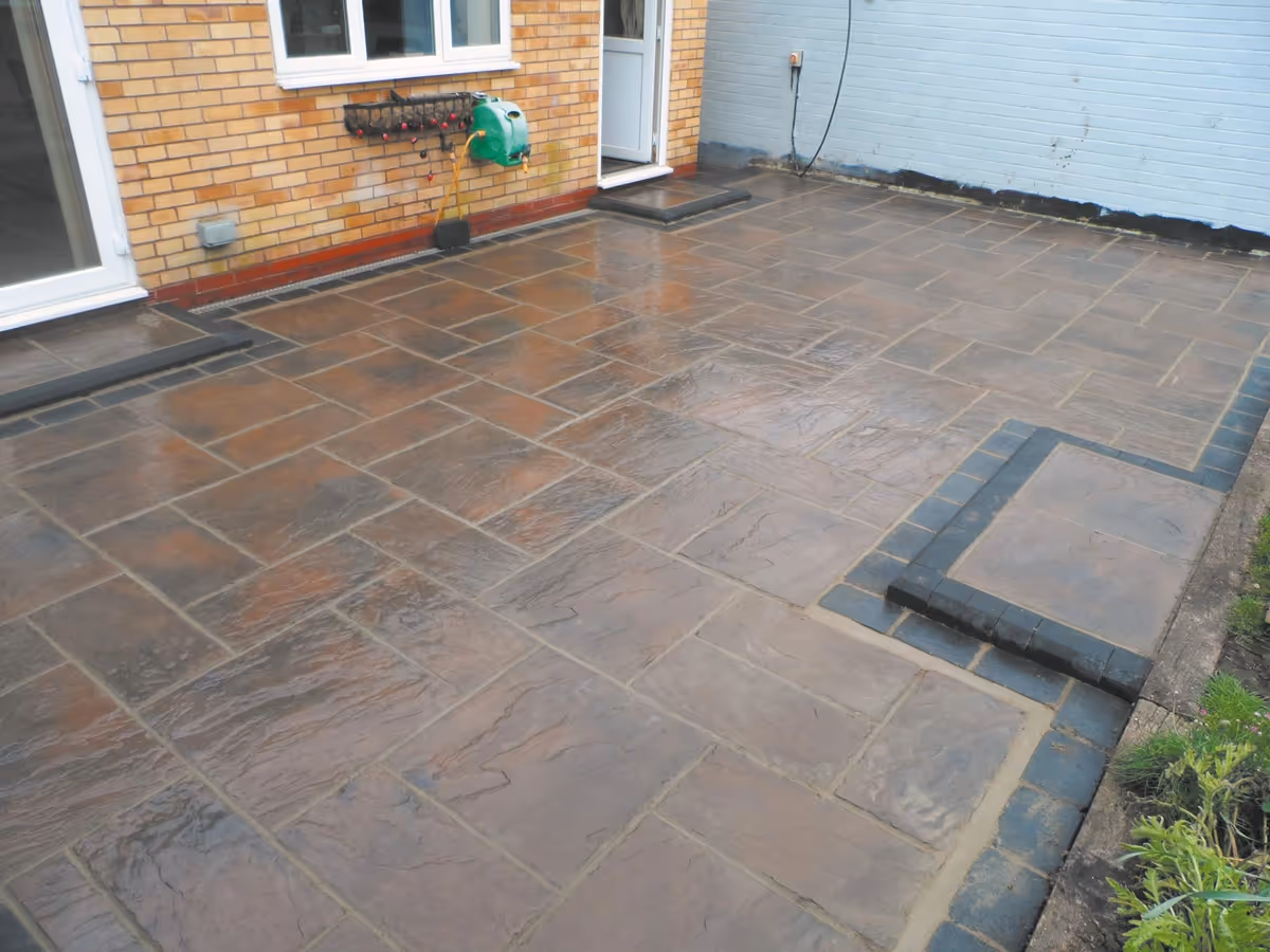Two size autumn gold concrete patio with charcoal rumbled block and matching concrete steps built with key set kerbs - angle 3