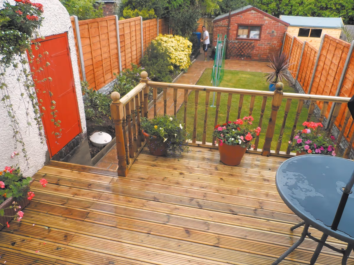 Mixed size autumn gold concrete patio, raised treated decking area and new lawn. 