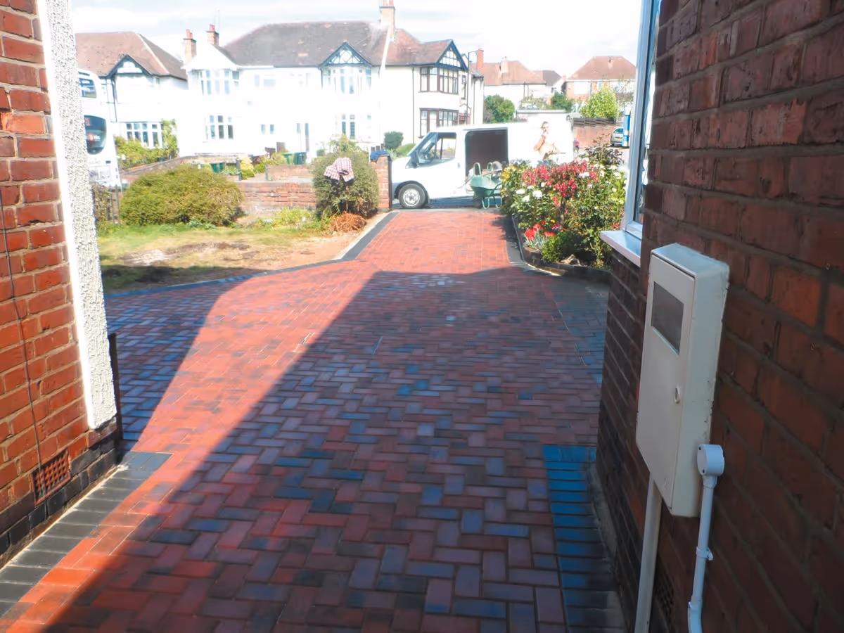 Brindle standard paving set driveway with charcoal borders, K.L kerb steps and planter retainers and an ACO channel drainage system - angle 4