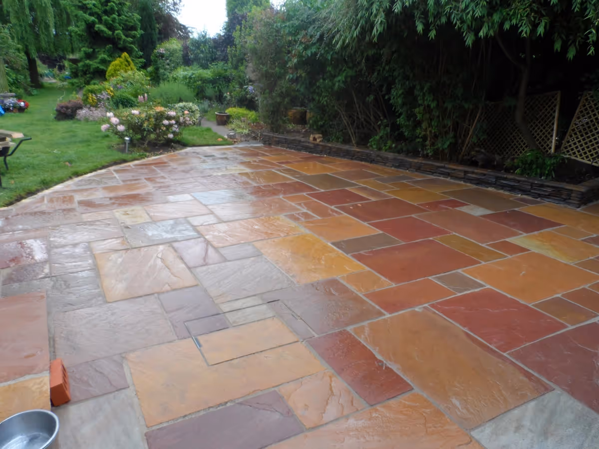 Modak natural stone patio with Raj natural stone sets, winter stone concrete walling and copings, gravel, stepping stones and decking - angle 4