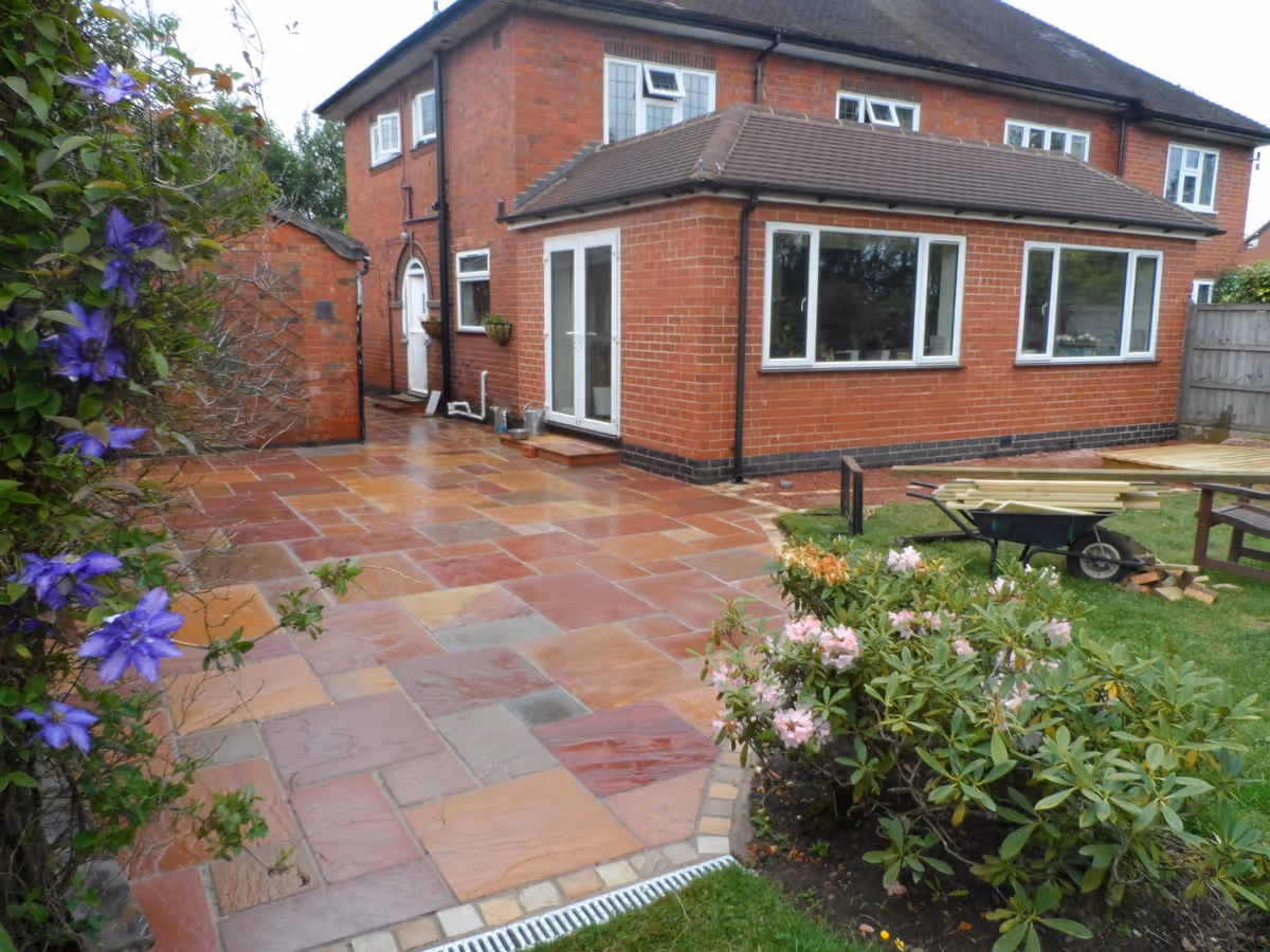 Modak natural stone patio with Raj natural stone sets, winter stone concrete walling and copings, gravel, stepping stones and decking - angle 2