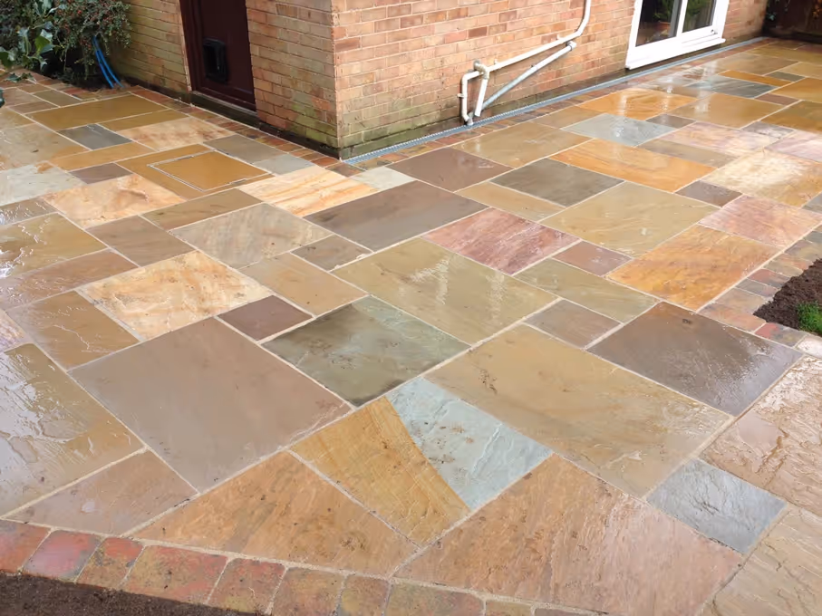 Mixed size camal natural stone patio with three size autumn mix rumbled block border - angle 2