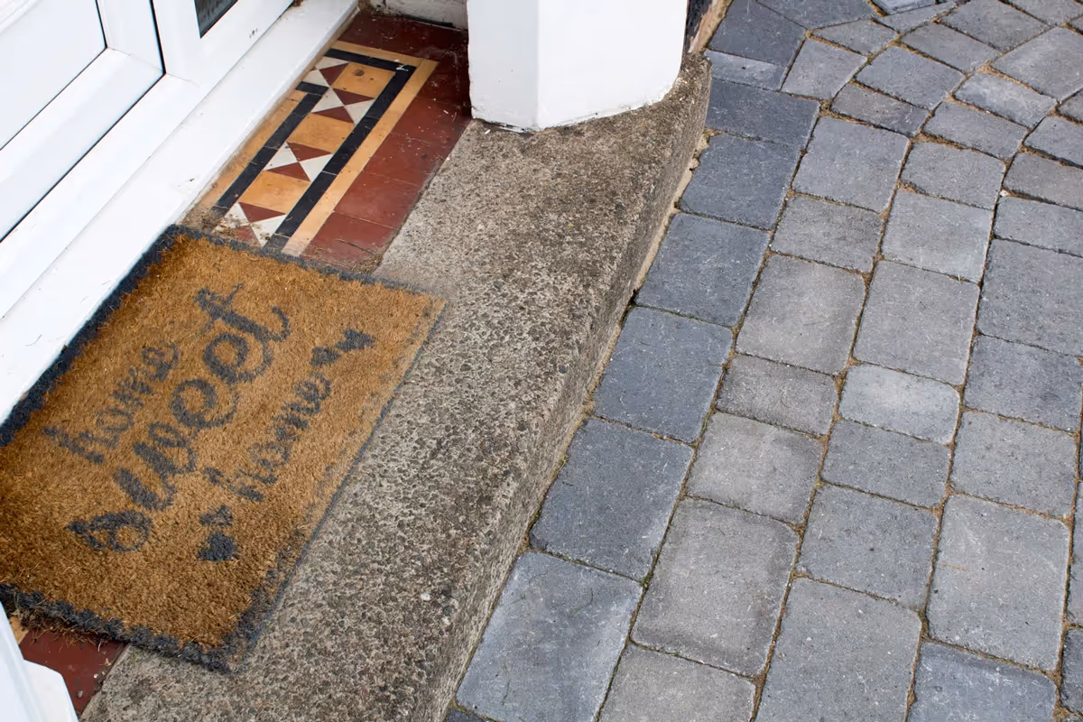 Ash Rumbled paving set driveway with triple border in charcoal, new lawn area retained with K.S kerb sets - angle 3