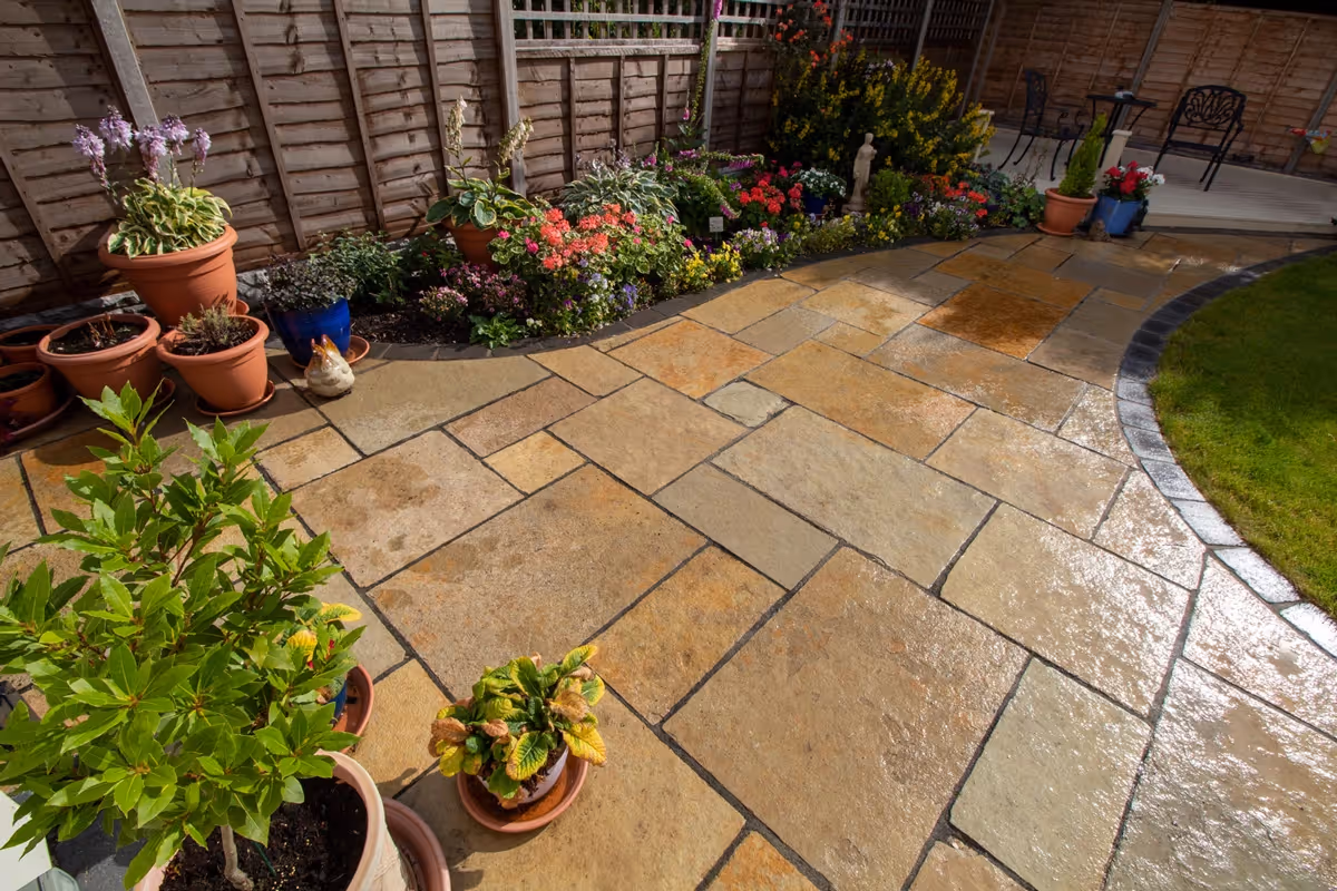 Mixed size yellow limestone patio with large charcoal rumbled block.  - angle 4