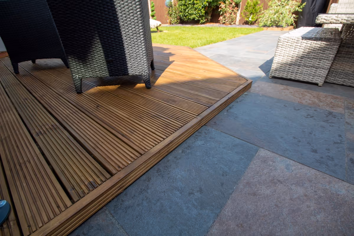 Mixed sized rustic porcelain patio, raised treated decking area and a new lawn and finished with blue slate.  - angle 2