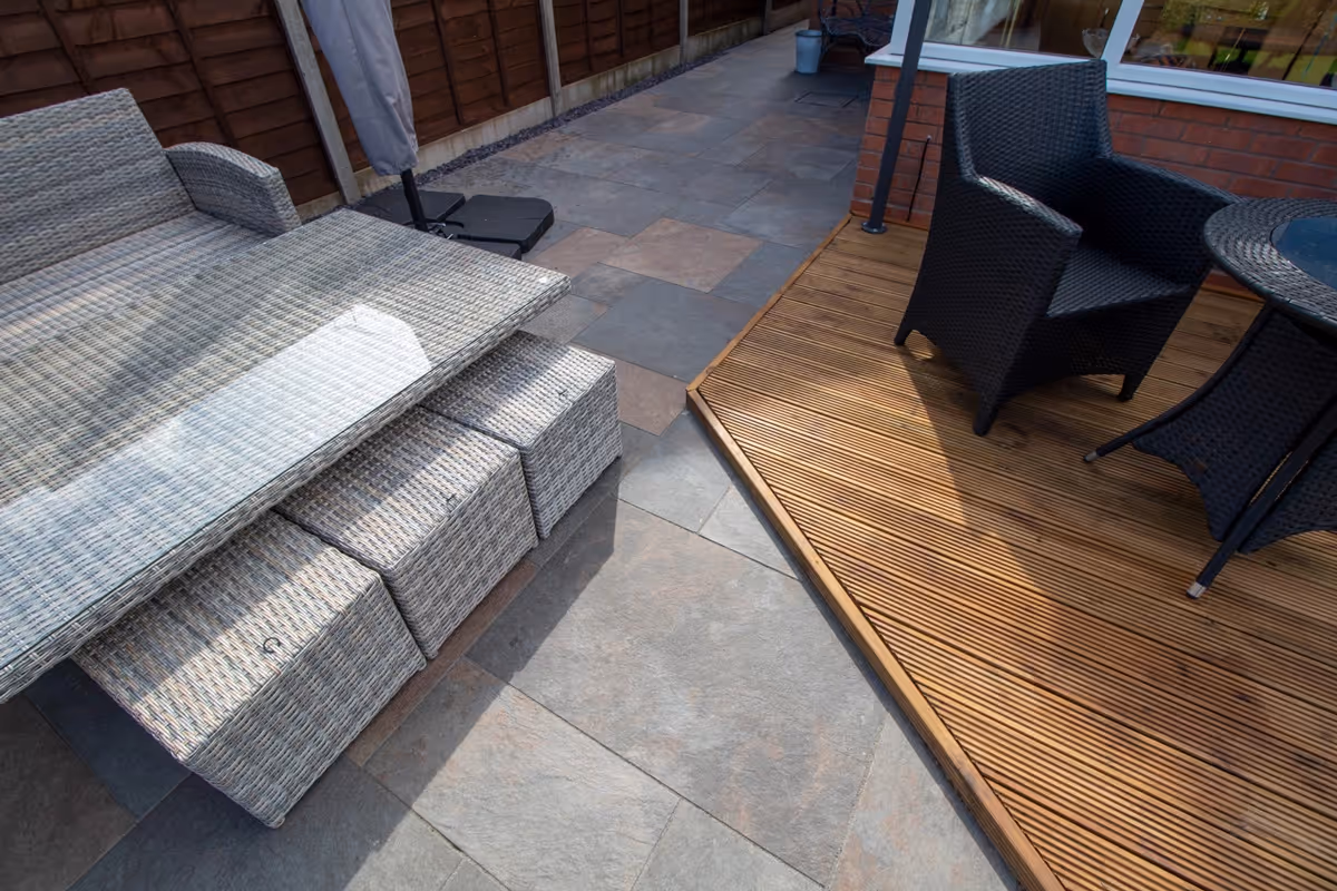 Mixed sized rustic porcelain patio, raised treated decking area and a new lawn and finished with blue slate.  - angle 8