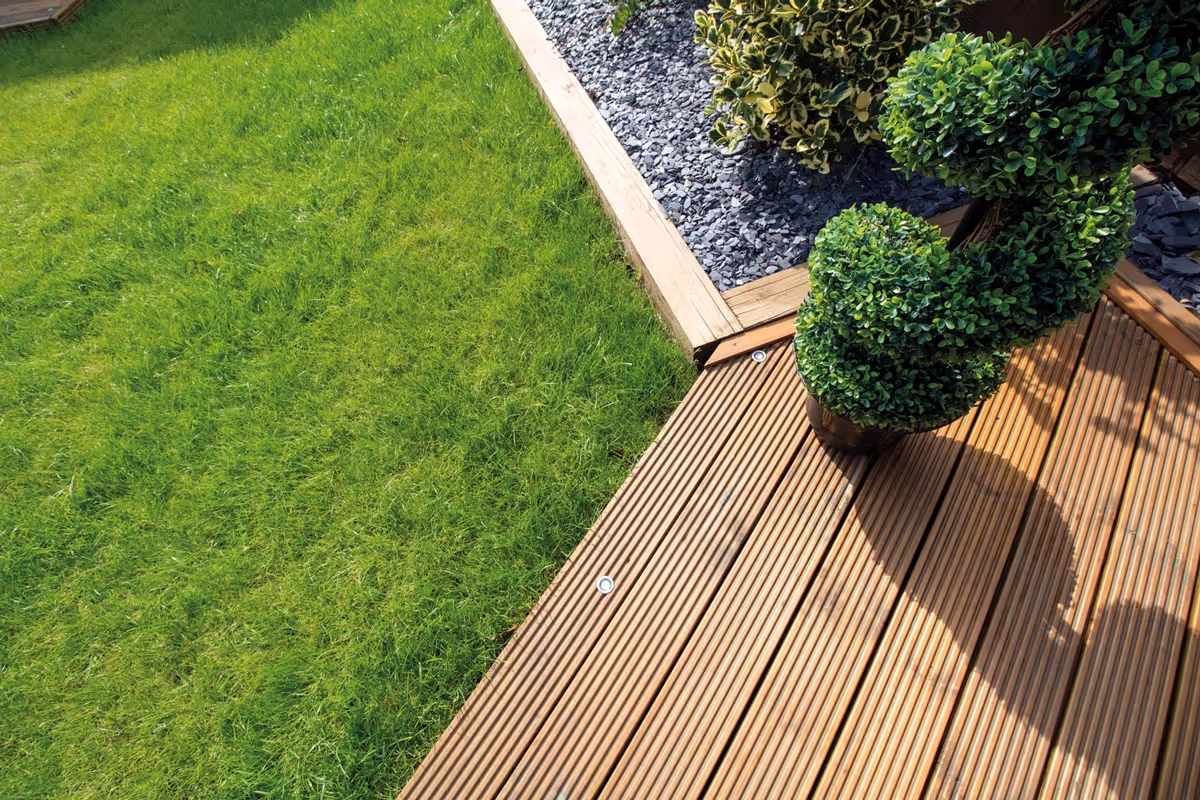 Mixed sized rustic porcelain patio, raised treated decking area and a new lawn and finished with blue slate.  - angle 5