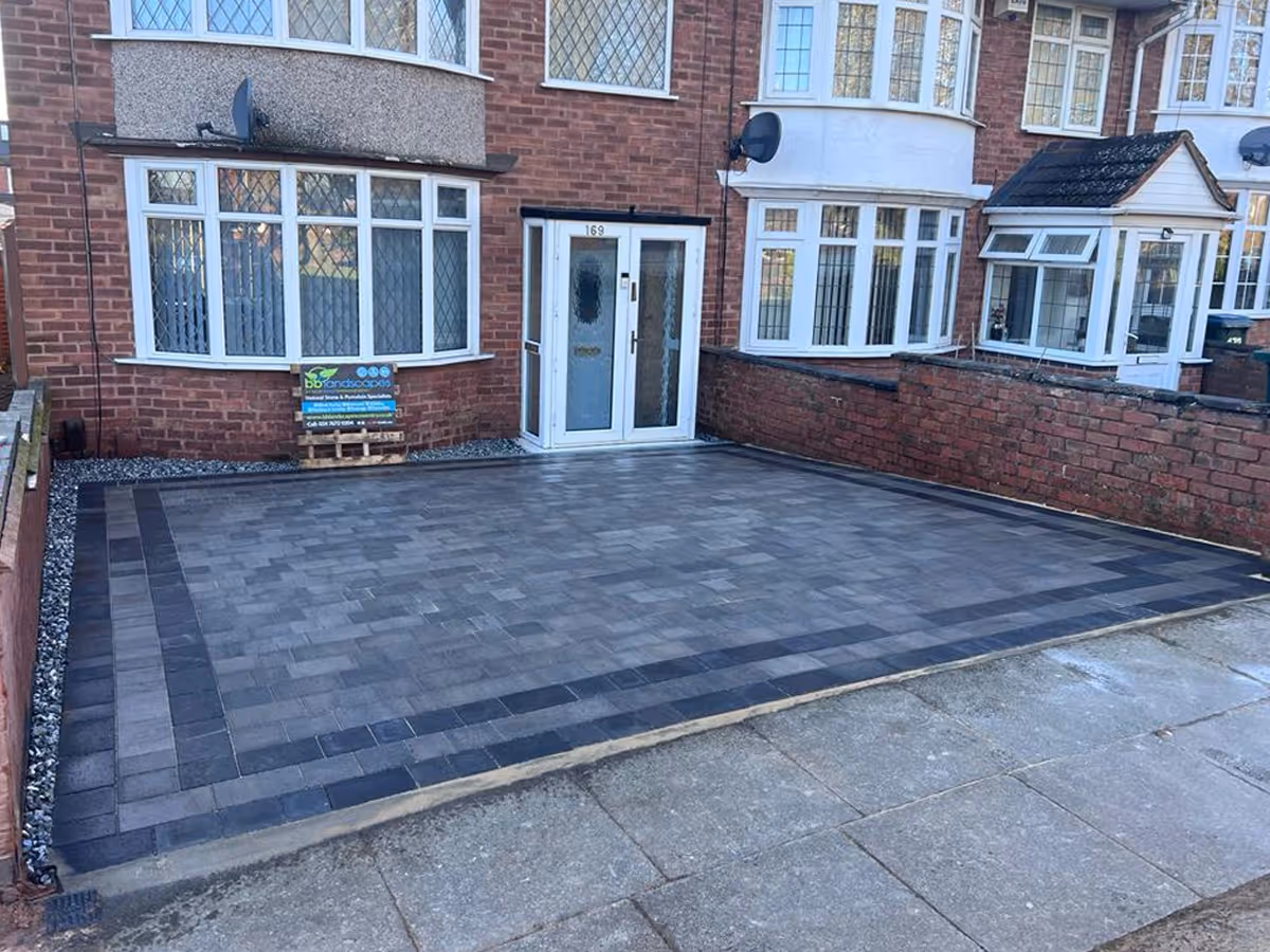 Silver grey pencil edge mixed-size paving. Triple border using charcoal pencil edge paving. ACO drainage system - angle 2