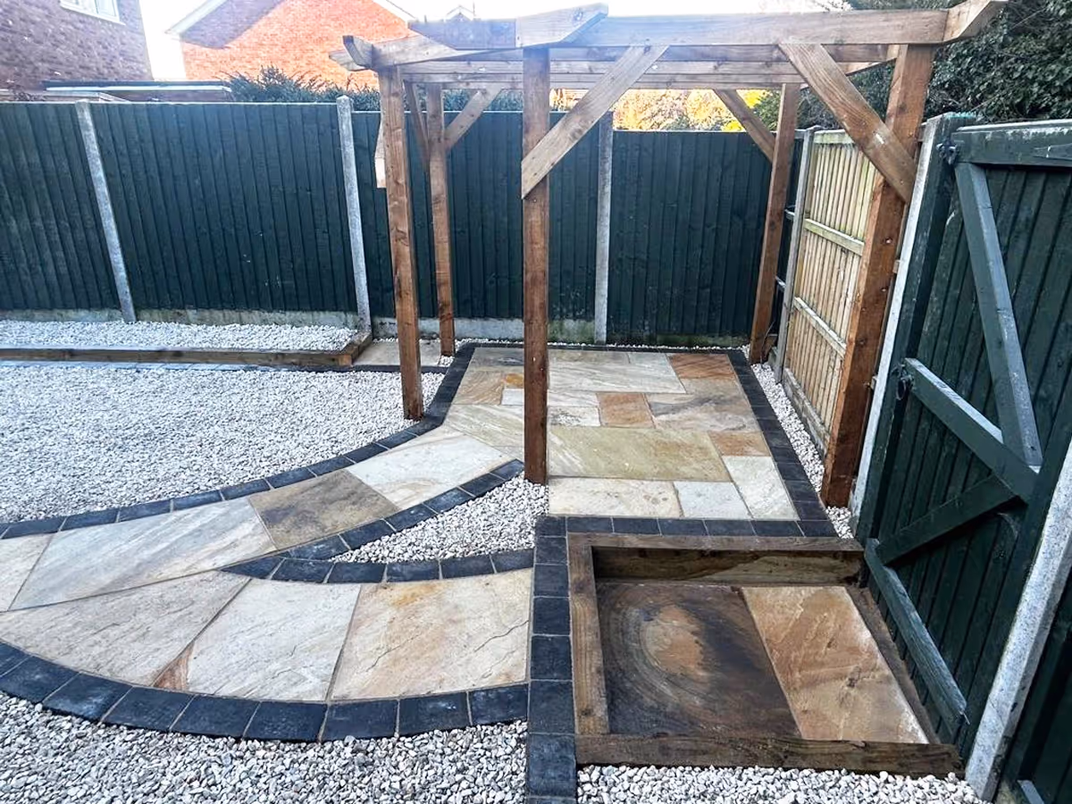 Mixed Size Fossil Buff Natural Stone, Cotswold 20mm Chippings Charcoal Rumbled Borders and retaining sleepers - angle 5