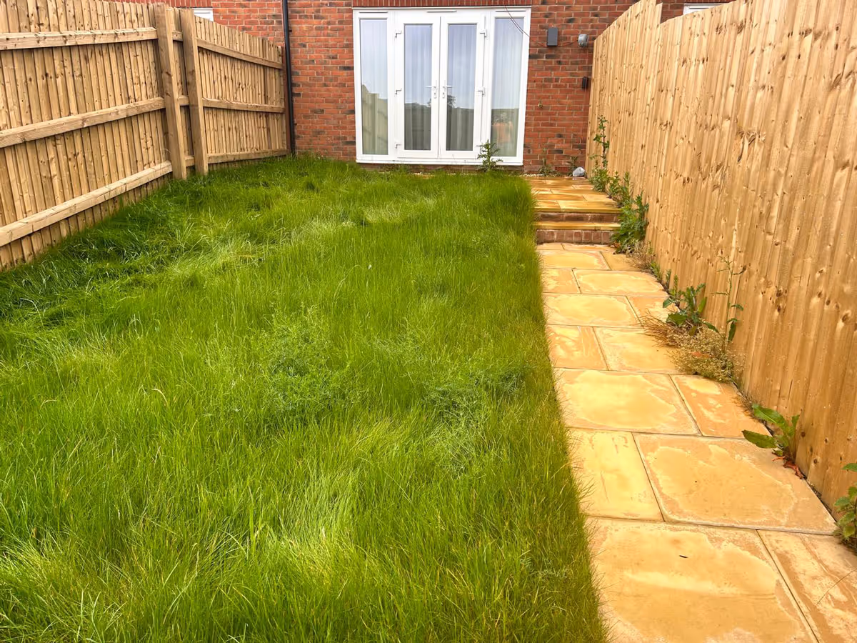 Mixed size natural stone patio and artificial lawn