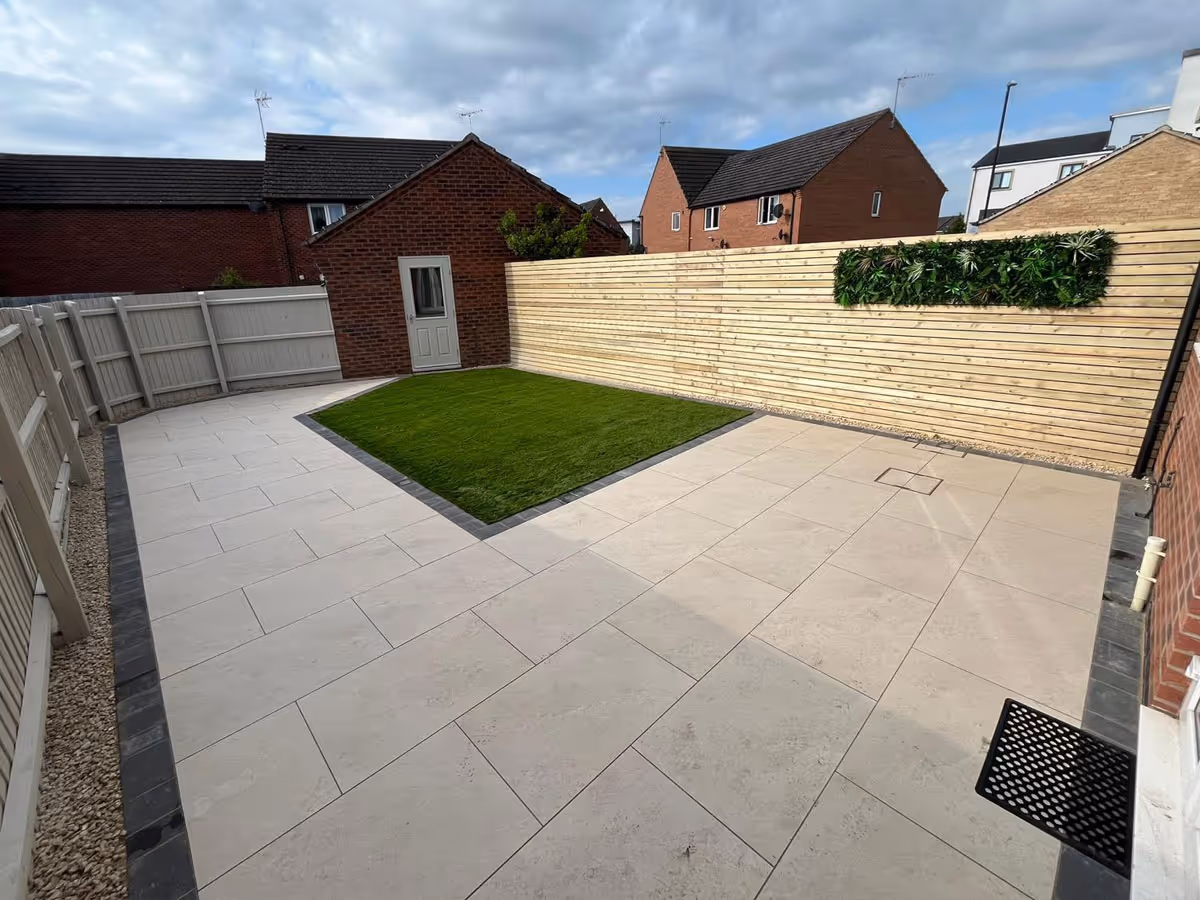 Porcelain patio with charcoal pencil edge paving and lawn