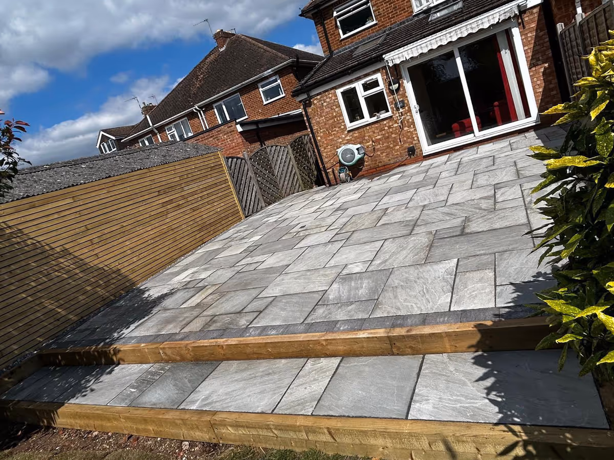 Natural stone patio with sleepers