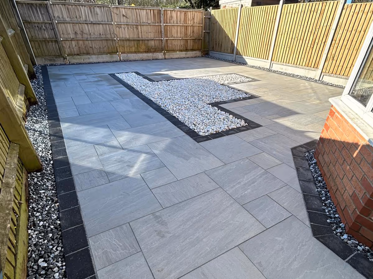 Mixed sized porcelain patio with gravel and charcoal pencil edge paving
