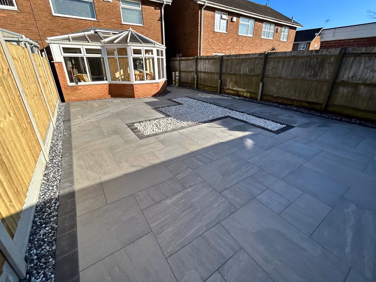 Mixed sized porcelain patio with gravel and charcoal pencil edge paving - angle 1