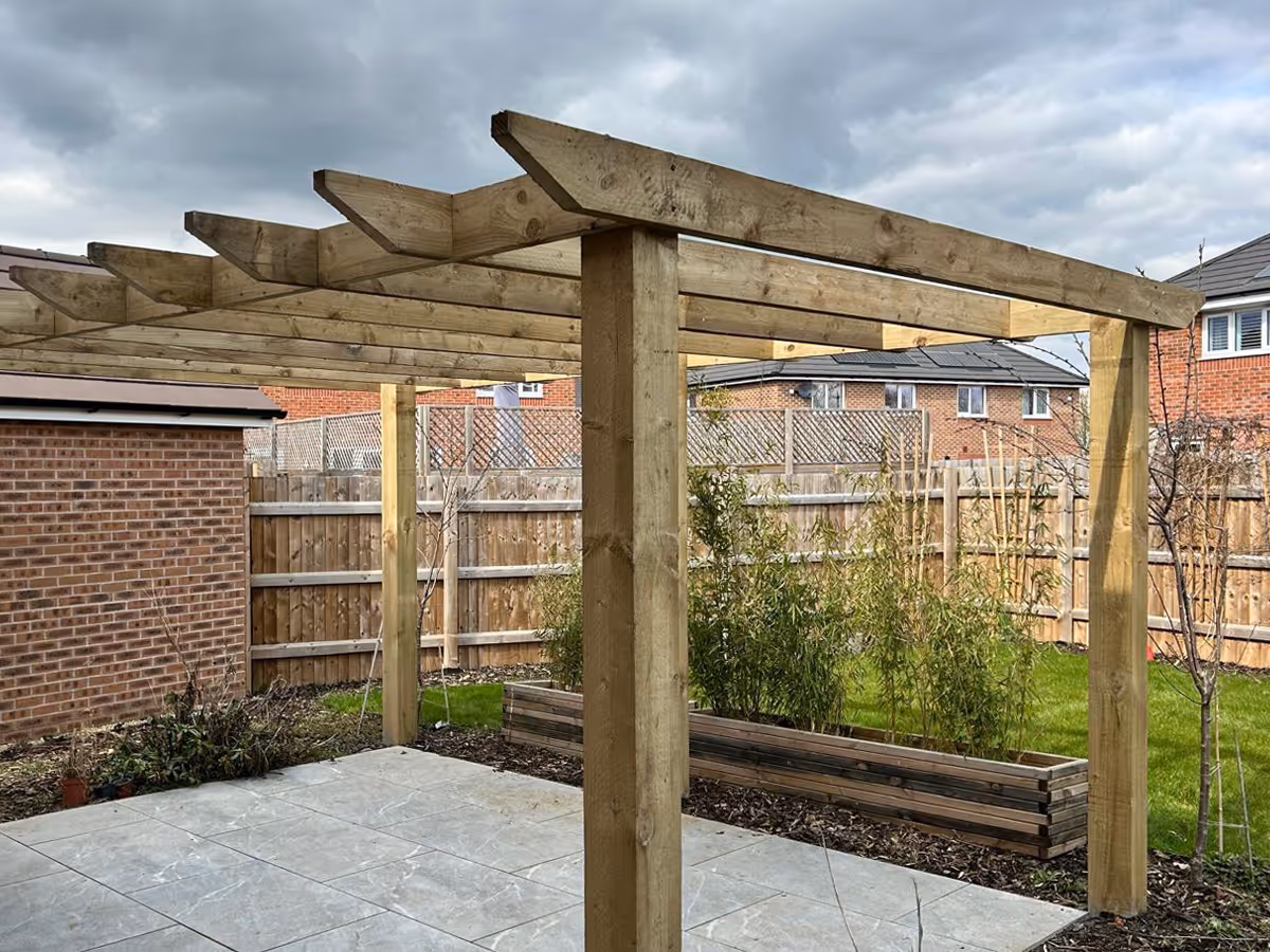 Natural stone patio timber frame pergola and wooden planters - angle 3