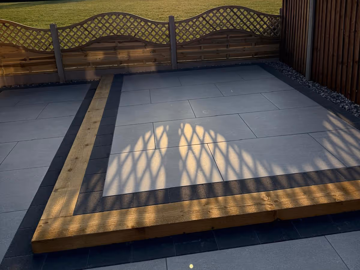 Garden room, porcelain patio with charcoal pencil edge paving and sleepers. - angle 6