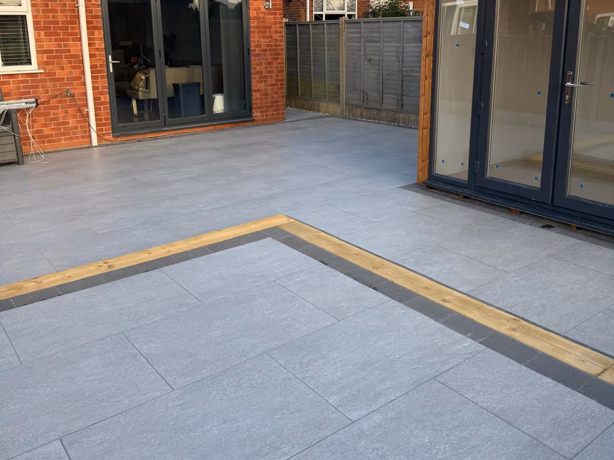 Garden room, porcelain patio with charcoal pencil edge paving and sleepers. - angle 2