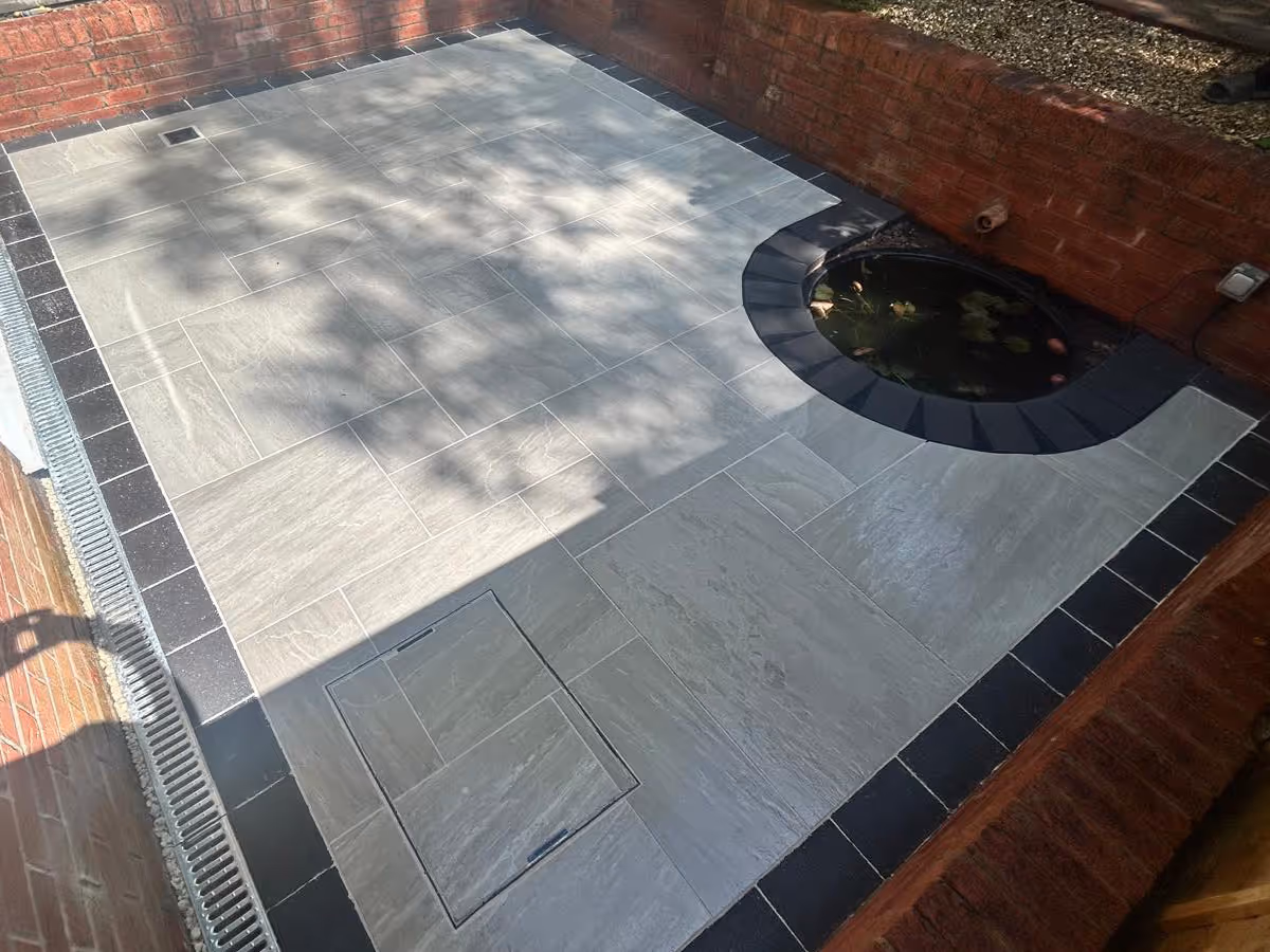 Mixed-size porcelain slabs with charcoal pencil edge paving - angle 1