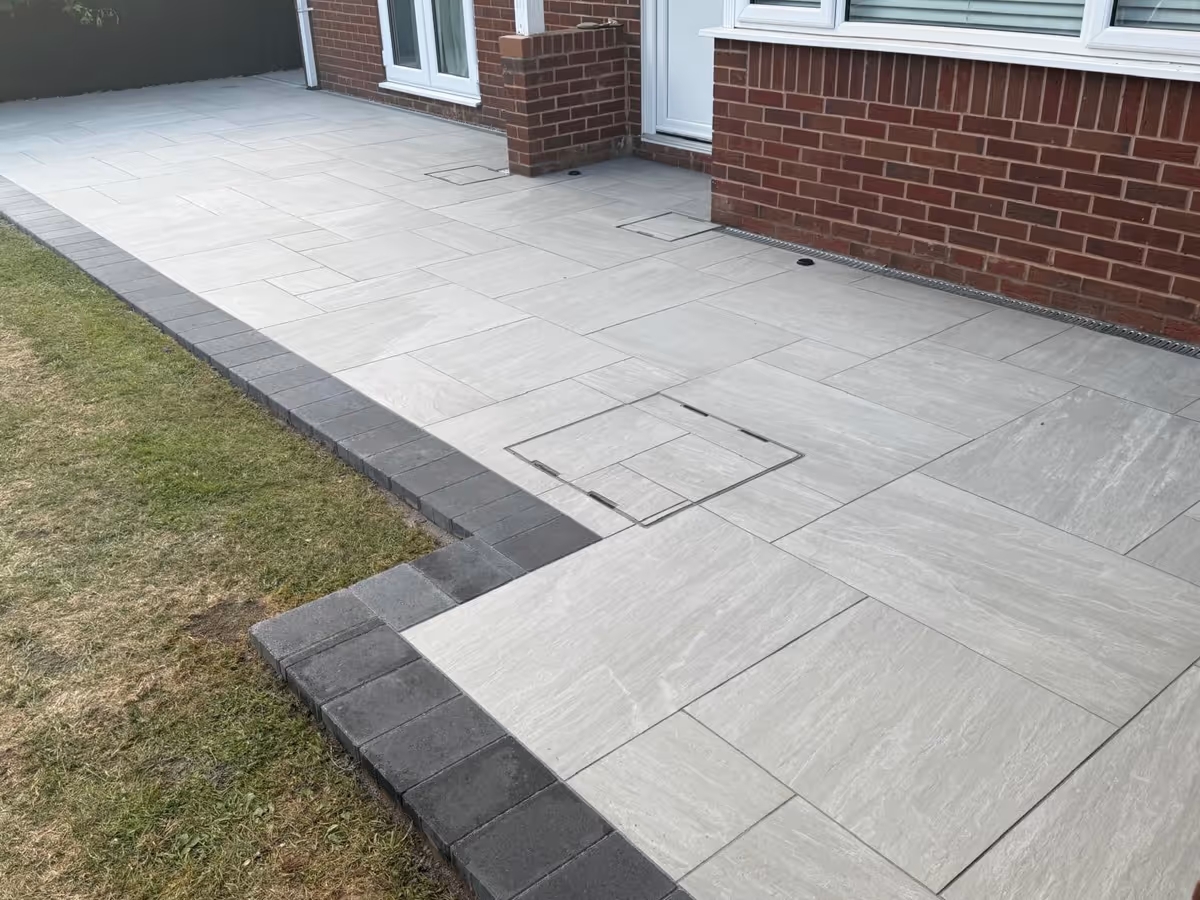 Mixed-size porcelain slabs with charcoal pencil edge paving - angle 1