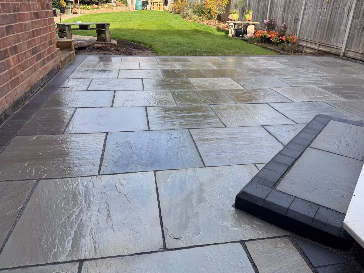 Total Stone Grigio porcelain patio with charcoal pencil edge paving.  - angle 1