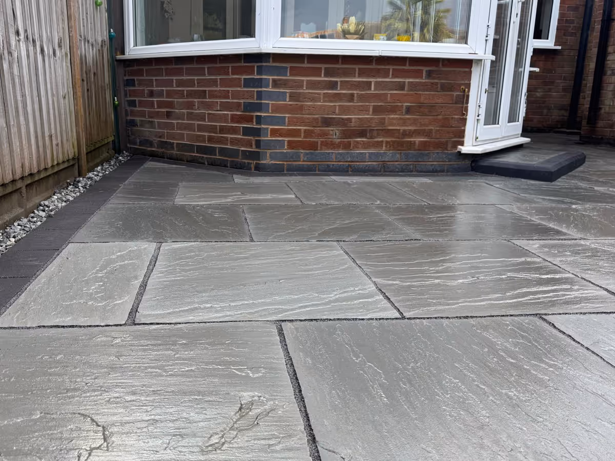 Total Stone Grigio porcelain patio with charcoal pencil edge paving.  - angle 3