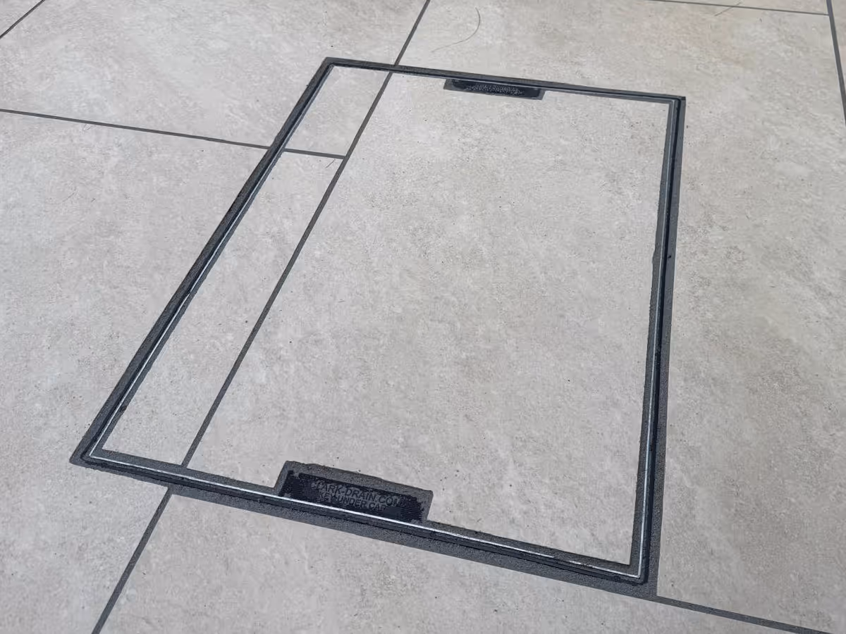 Grey porcelain patio with sleeper retainers and decorative chipping - angle 4