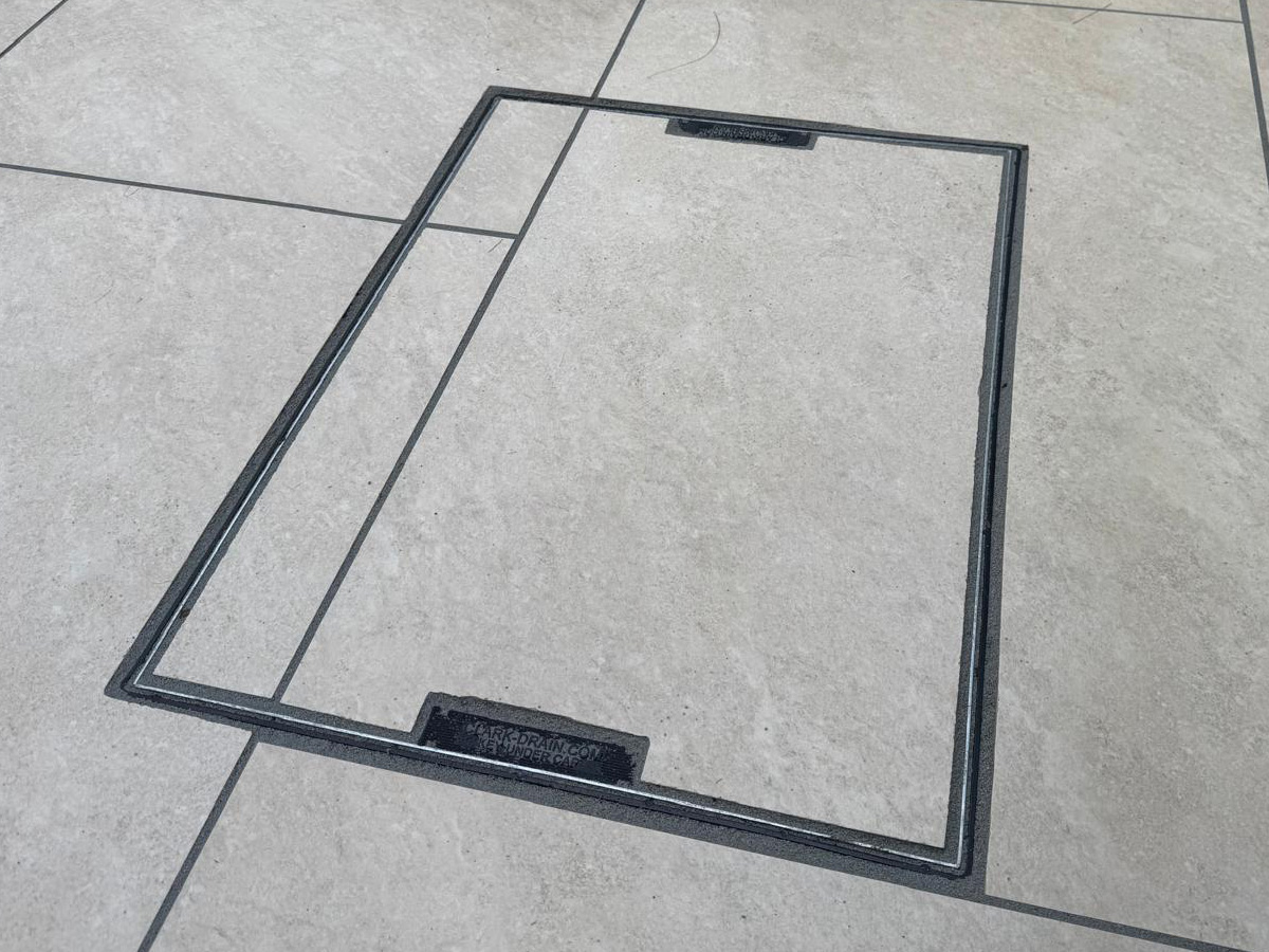 Grey porcelain patio with sleeper retainers and decorative chipping - angle 4