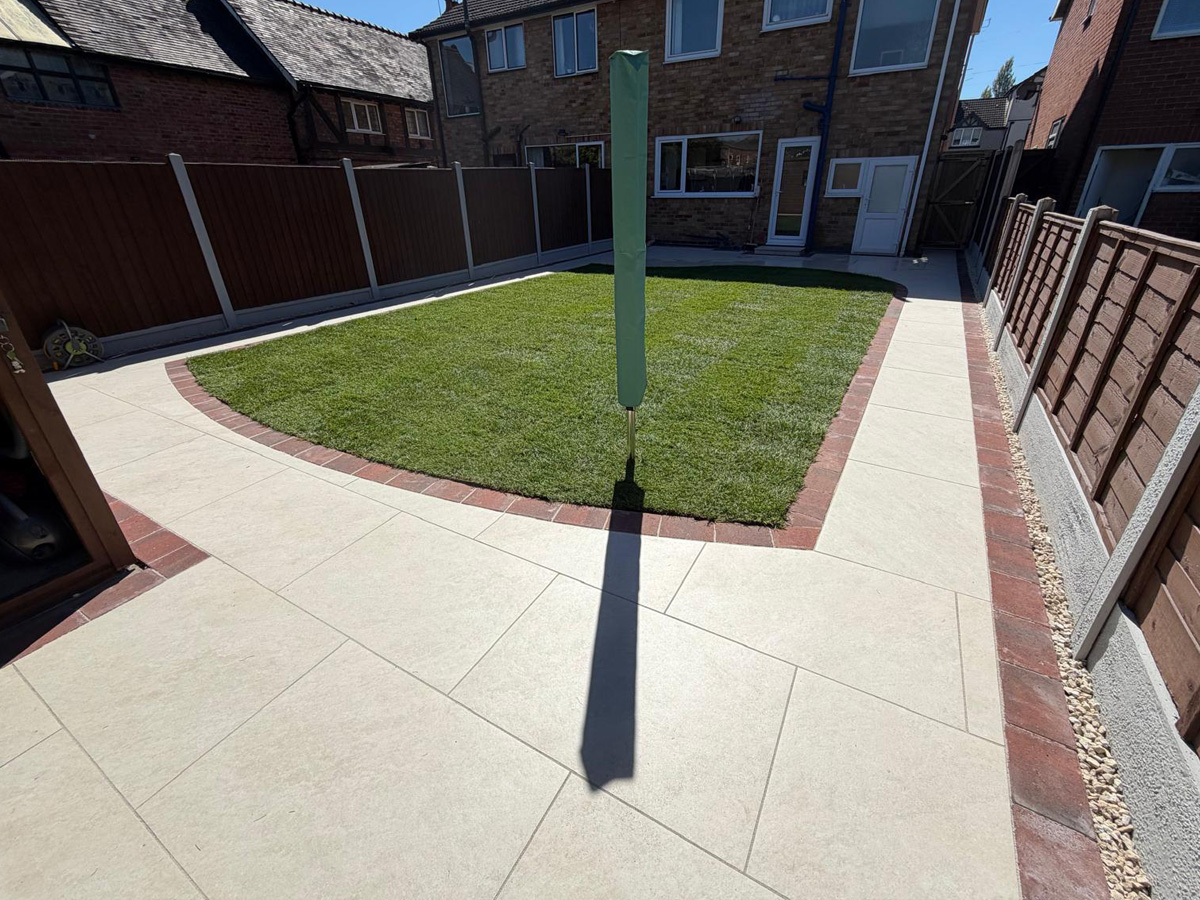 Cream porcelain patio with pencil edge paving and lawn