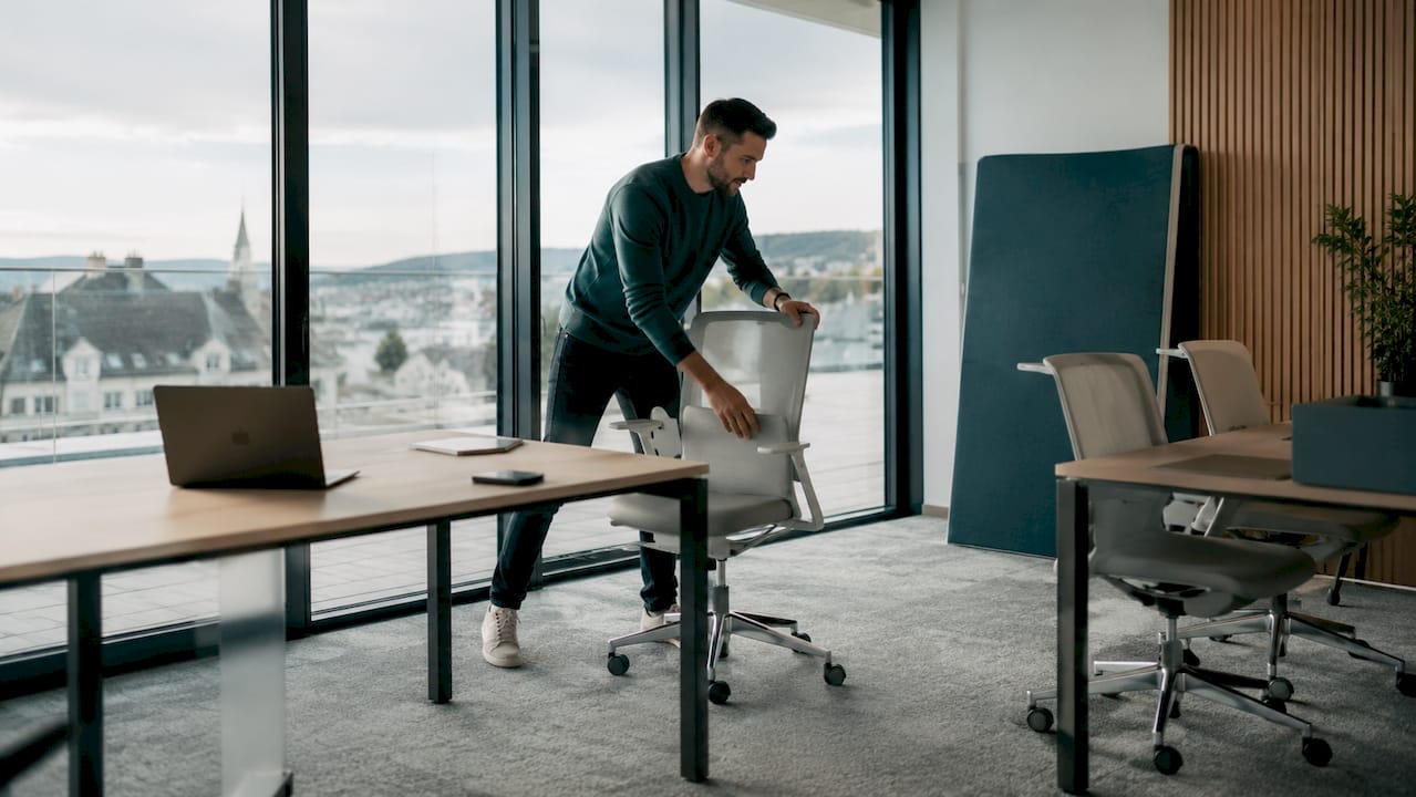 Office worker arranging modular furniture pieces