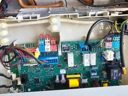 Boiler circuit board inspected during a fault diagnosis in East Dulwich