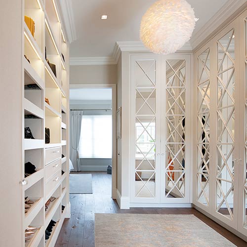 An L-shaped wardrobe with glass panels