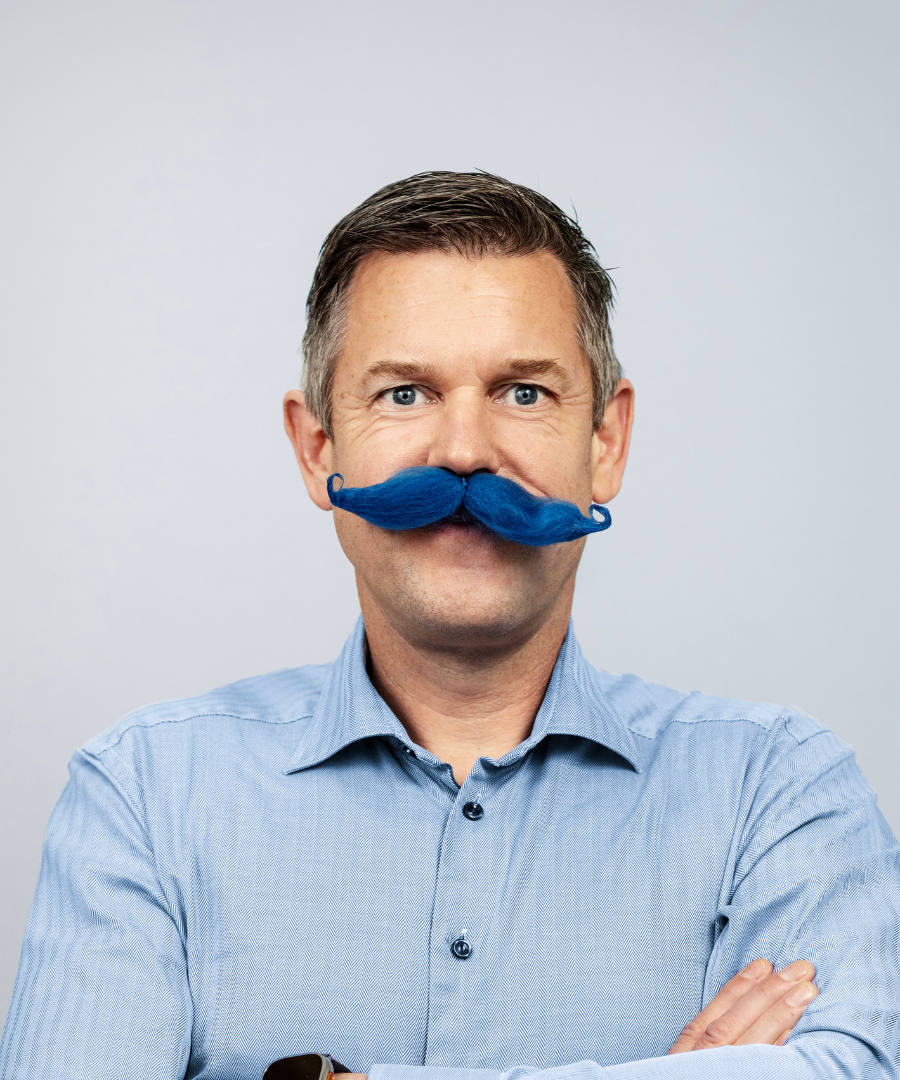 Bild på generalsekreterare i blå mustasch