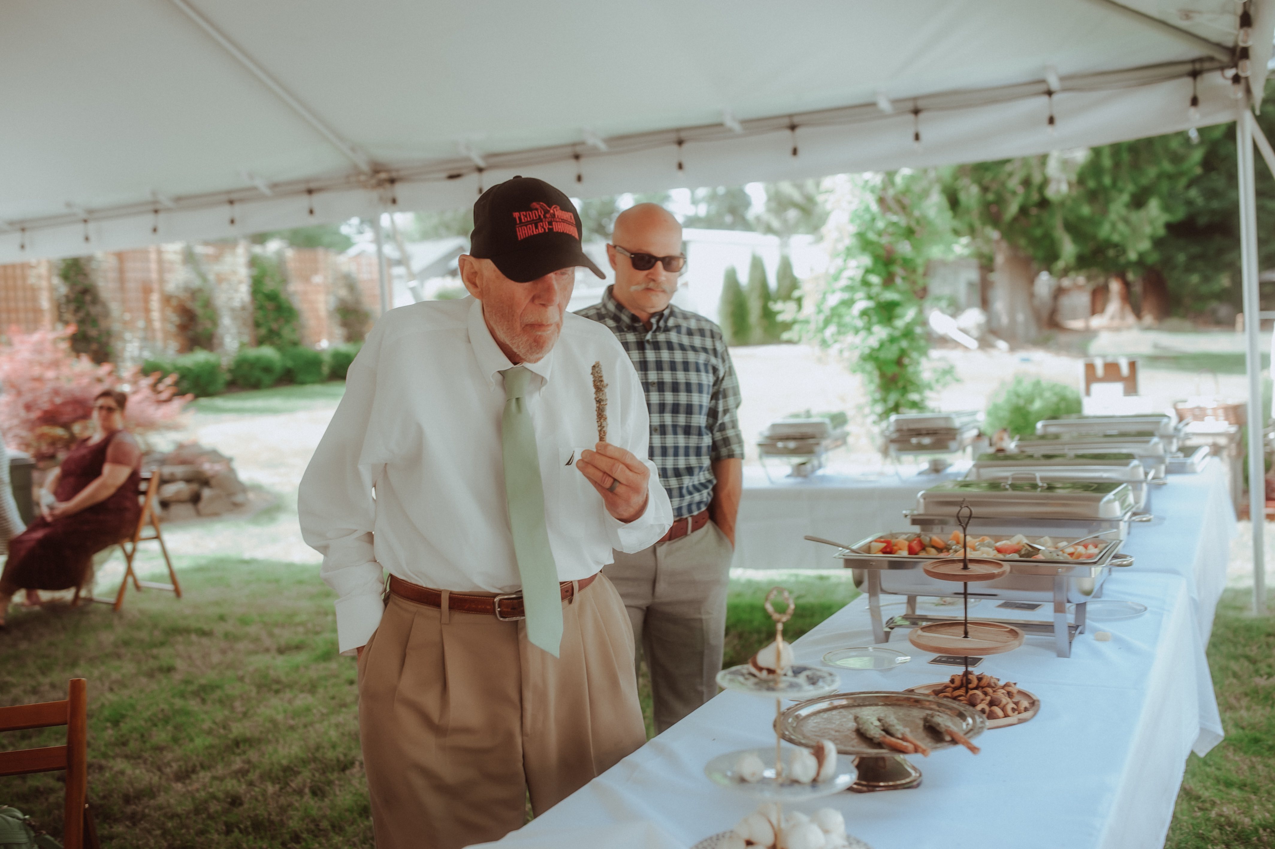 two men at a table with food