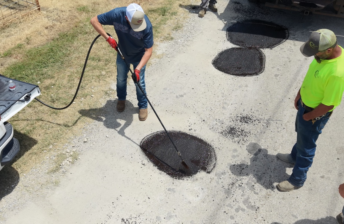 PCT spray equipment applying asphalt repair material