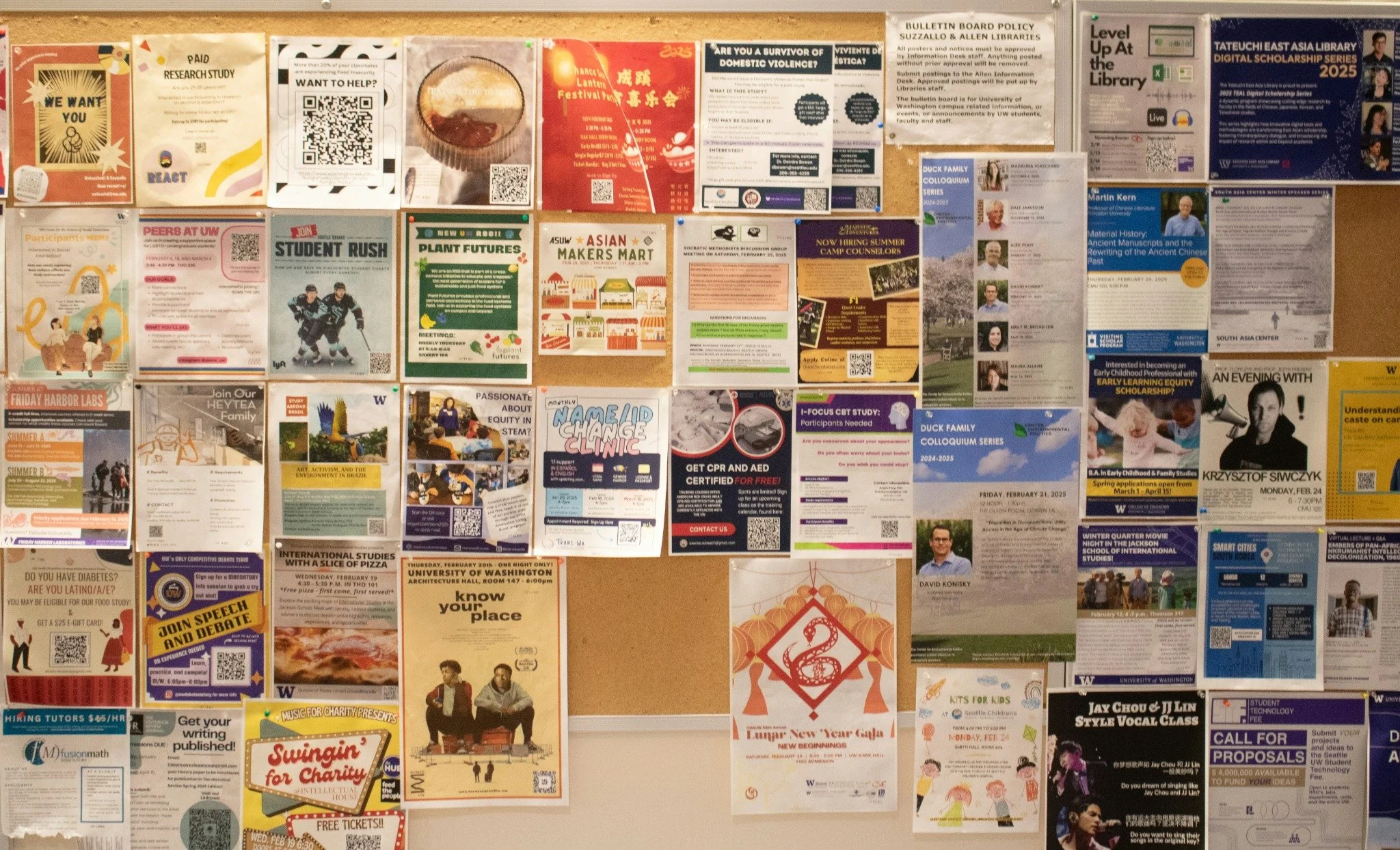 A bulletin board covered with diverse colorful flyers and posters about campus events and programs.