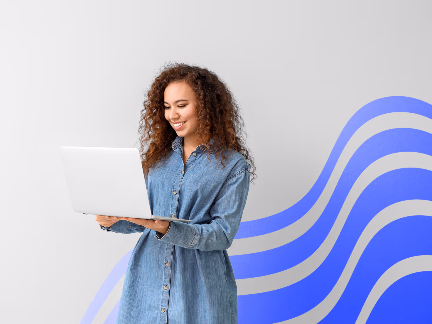 Woman smiles as she holds her phone descending stairs
