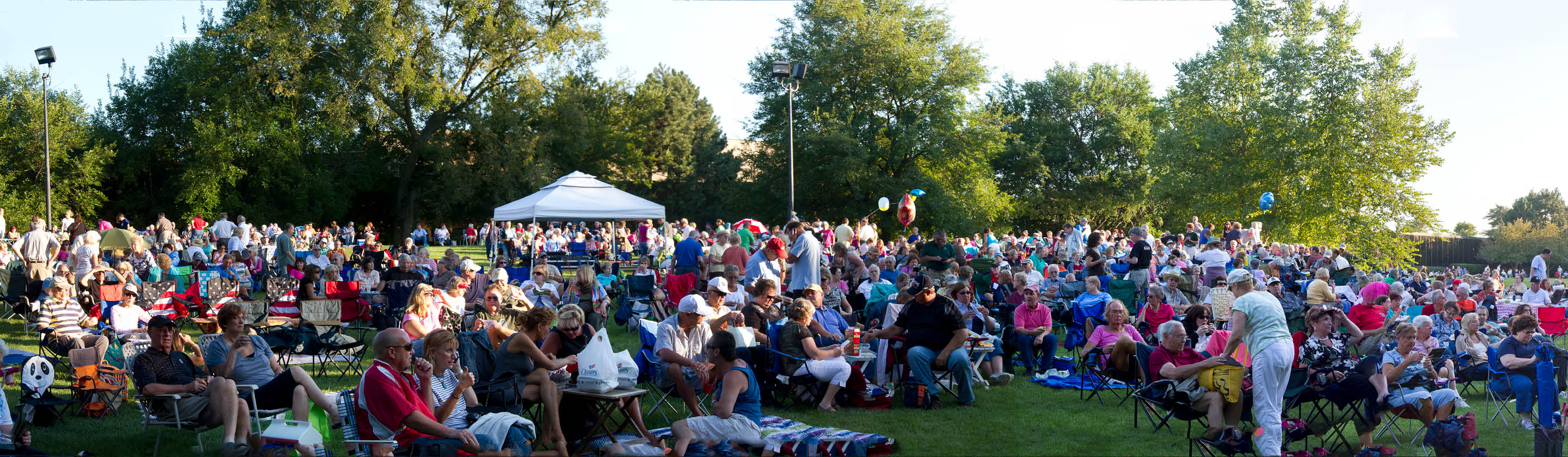 Large crowd in lawn chairs at a Summer Breeze outdoor concert at the Prairie Center for the Arts.