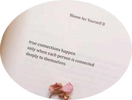 Open book page with text 'Bloom for Yourself II' and a quote about true connections, with dried pink petals below the text.